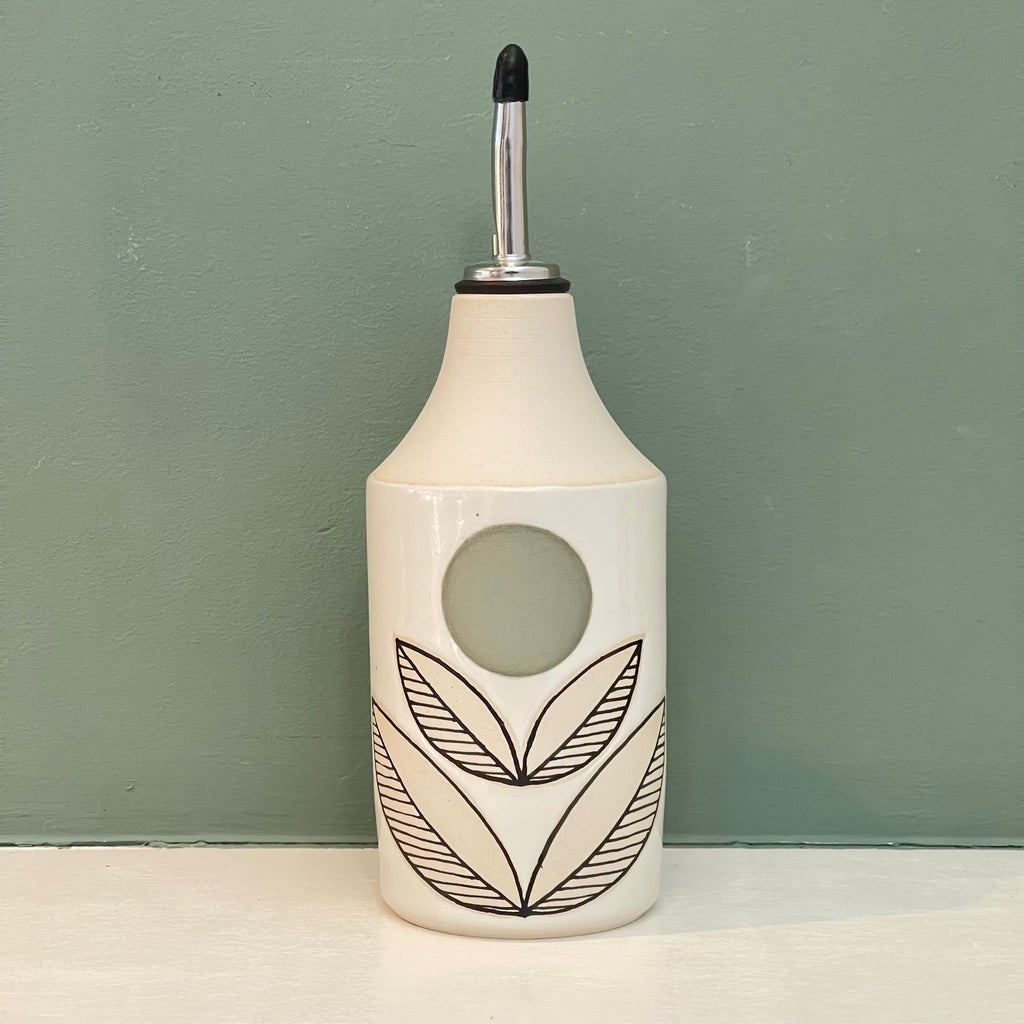 our olive oil and vinegar pour just got an upgrade with these super cool oil bottles by Judith Lemmens, designer behind the Julems line of wheel thrown ceramics. The hand drawn design is a Julems feature. This one in a stylized flower pattern with a geometric olive dot for the flower