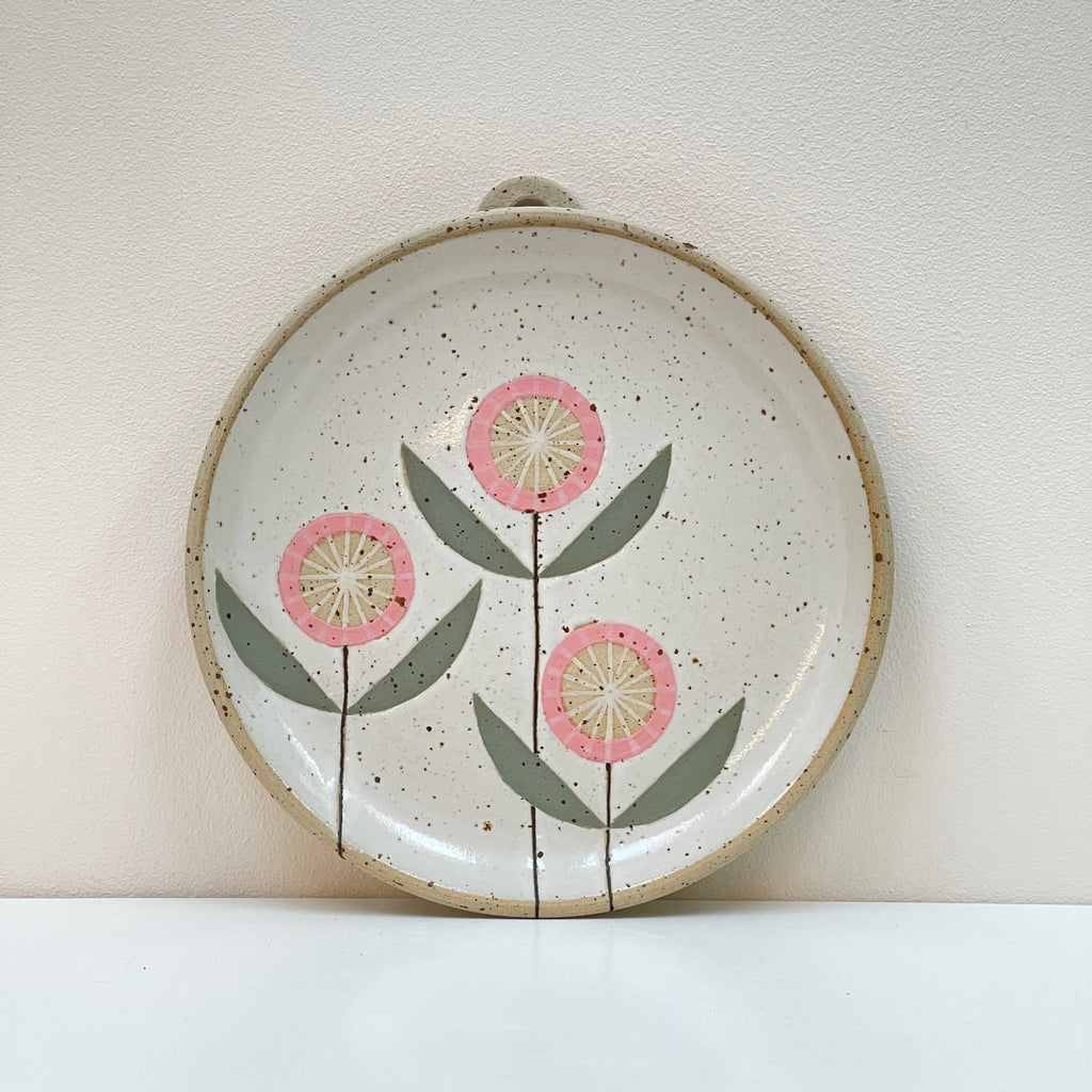 3 Pink Flowers decorate this ceramic wall hanging plate. A beautiful edition to your gallery wall! We love the dark pink flower geometric aesthetic by Julems Ceramics