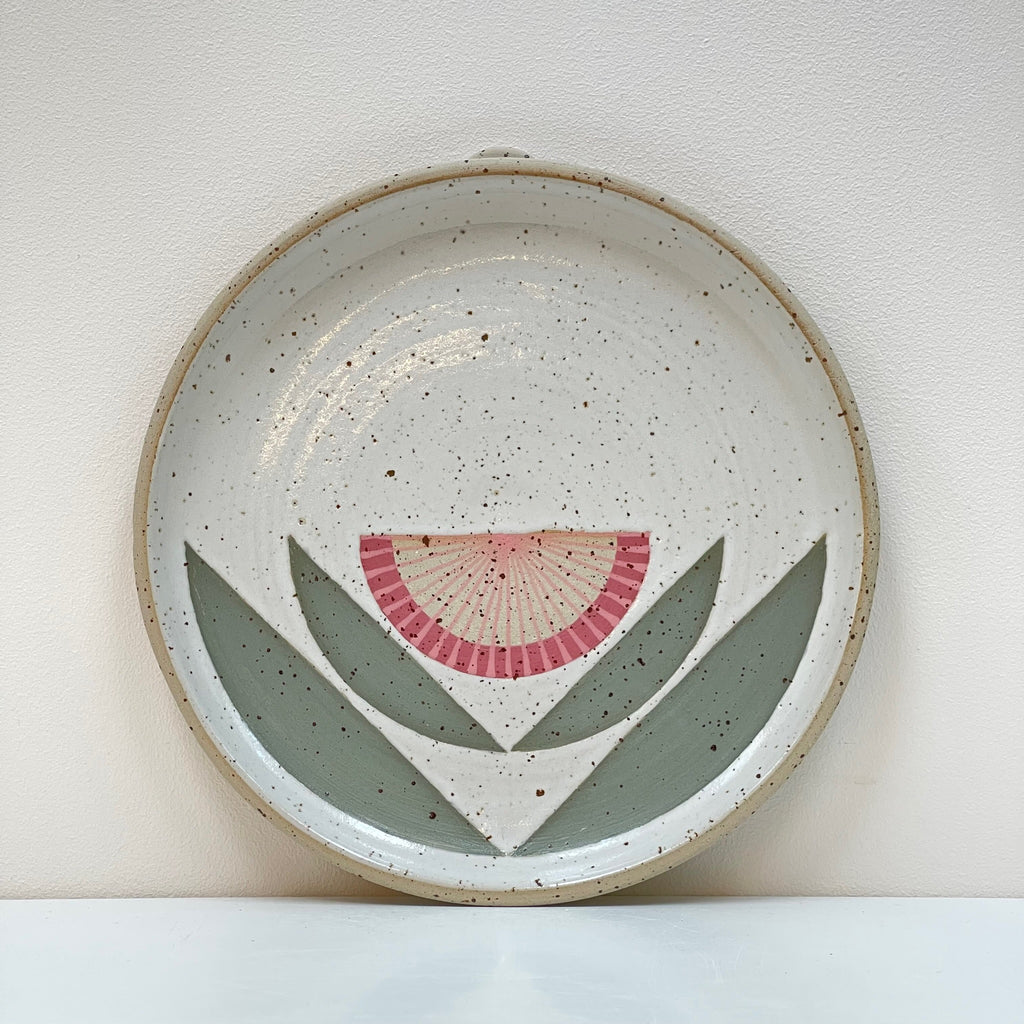 A hanging wall plate is a beautiful edition to your gallery wall! We love the dark pink flower geometric aesthetic by Julems Ceramics