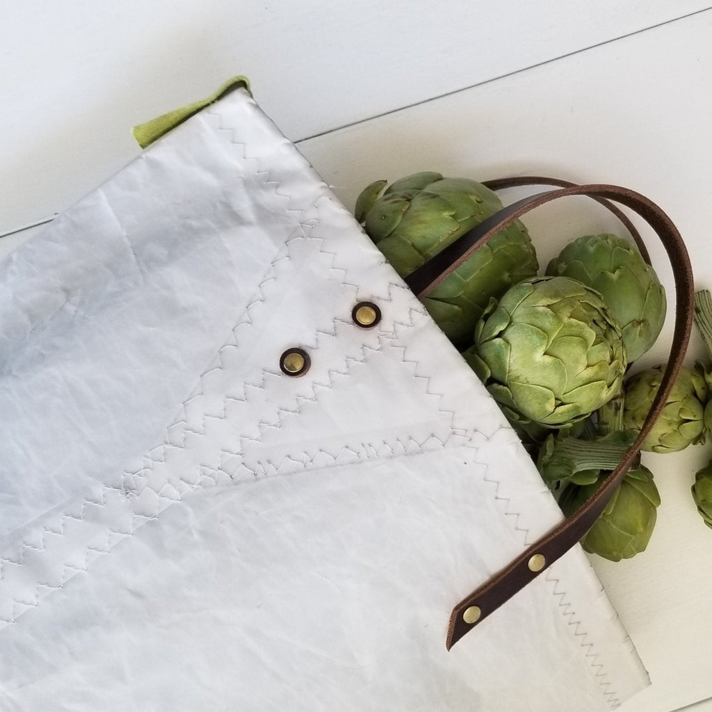 Tote bags instead of plastic bags! Use these Landfall Leatherworks Provisioner open sail cloth bags to carry your farmer's market haul, swim suit and towel, beach reads and sketchpads. Shown with artichokes.
