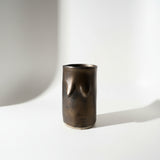 Bronze glazed tittie cup or vase on a white background