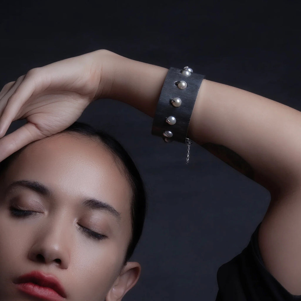 Claws of gleaming silver capture a collection of pearls embedded within the body of an etched silver bracelet. This domination bracelet is the edgiest modernization of pearls as only Mariella Pilato does in her fierce way! Shown on model
