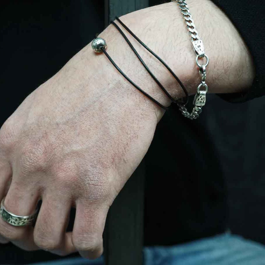 The 5.5mm sterling silver curb chain is sand cast into the end pieces which are then stamped with the word “f--k."