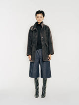 Model wearing Arden Brushed Wool and Cashmere Jacket, a single-breasted coat crafted from a luxurious blend of high-count Australian wool and cashmere. With a soft brushed effect, it holds an airy texture by Mute by JL New York