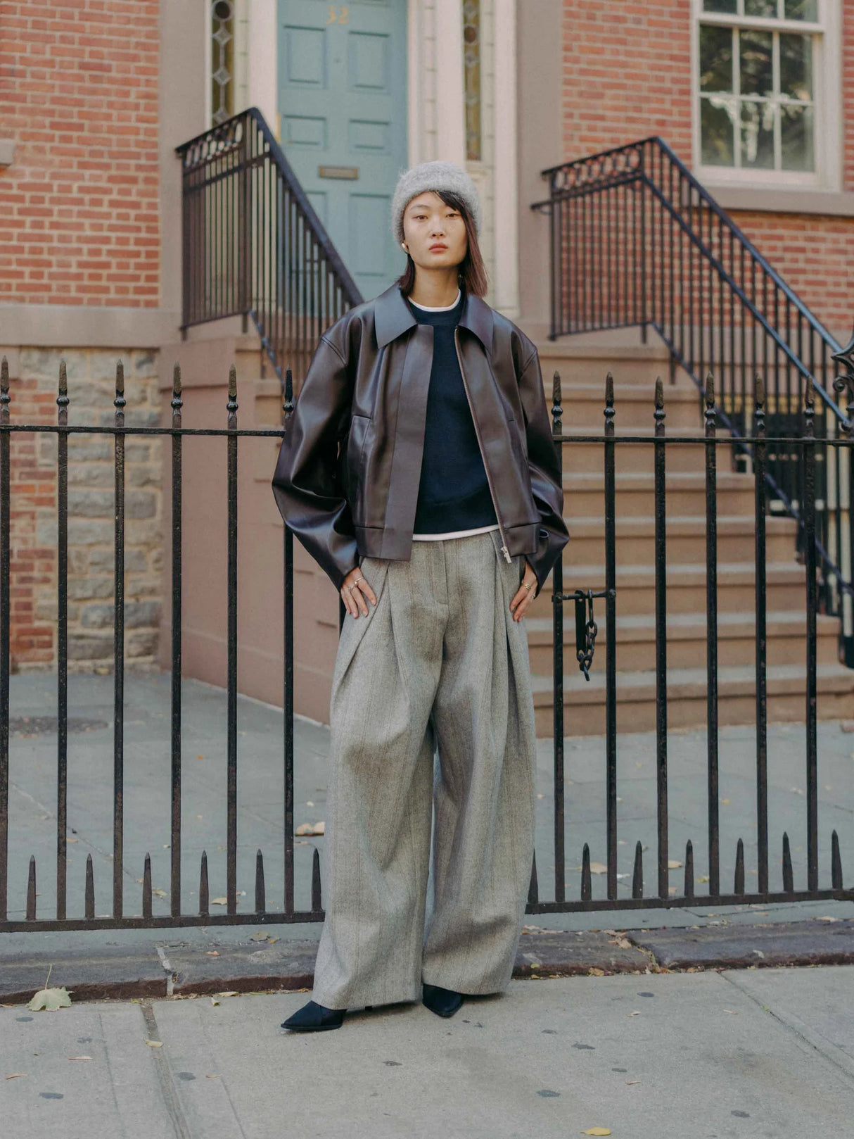 Mute by JL dark chocolate vegan leather jacket featuring a cropped silhouette with a boxy cut and an exaggerated pointed collar shown on model with Hayes Herringbone Tweed Wide Leg Pant