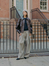 Mute by JL dark chocolate vegan leather jacket featuring a cropped silhouette with a boxy cut and an exaggerated pointed collar shown on model with Hayes Herringbone Tweed Wide Leg Pant