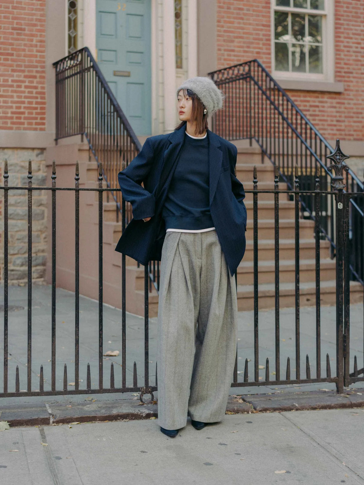 Hayes are an extra wide-leg herringbone tweed pattern pants crafted from a structured wool blend. They feature a high waist, and oversized pleats for added volume and movement. By Mute by JL. Shown on Model