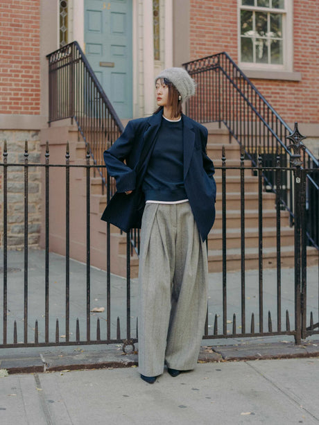 Hayes are an extra wide-leg herringbone tweed pattern pants crafted from a structured wool blend. They feature a high waist, and oversized pleats for added volume and movement. By Mute by JL. Shown on Model