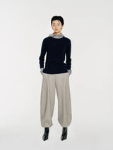 The Linden sweater by Mute by JL is crafted from 100% wool and features a soft mock neck that transitions into a draped hood for both function and form.