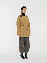 This double-breasted coat wool coat with contrast collar and ever so slightly avant garde curved sleeve seam lines