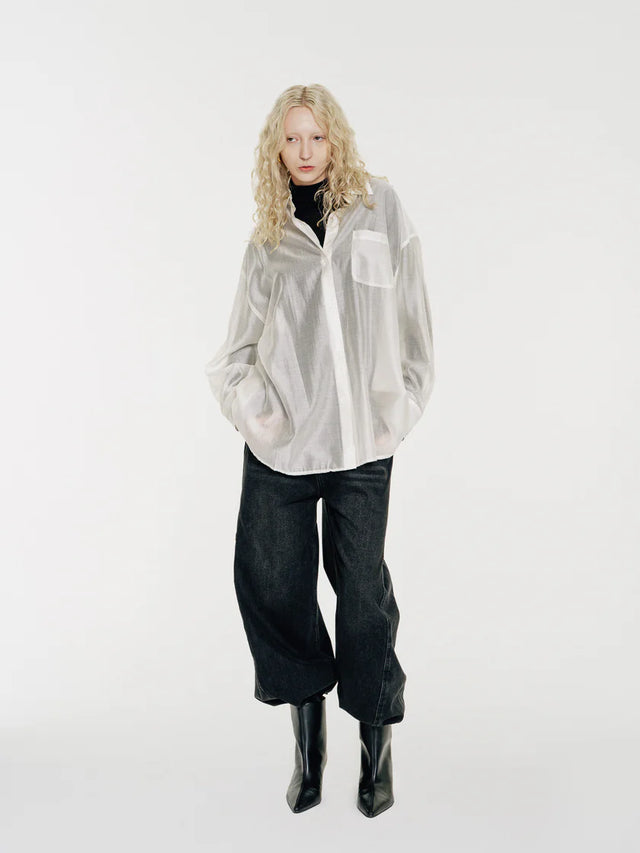 The Sol by Mute by JL is lightweight and fluid, an oversized shirt crafted from a semi-sheer Tencel fabric that features a silky touch and drapes with an effortless elegance. The soft translucency makes it a perfect layering piece