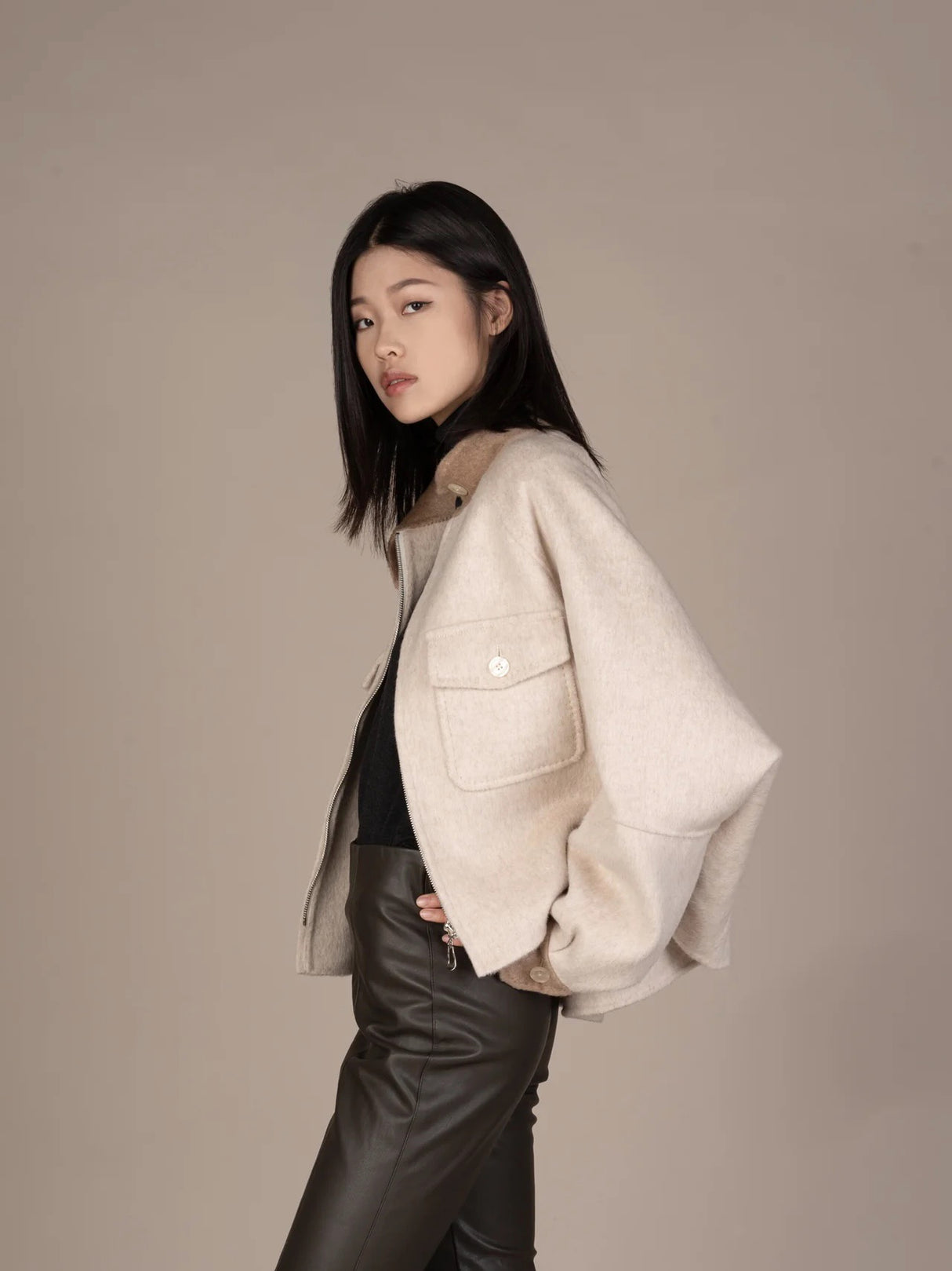 The Batwing sleeved Car Coat by Mute by JL is like a cocoon in its merino wool and vicuña blend. An elevated everyday substitute for a jean jacket, cape or poncho, the Car Coat keeps you warm and stylish with its zipper front and imperial collar. 