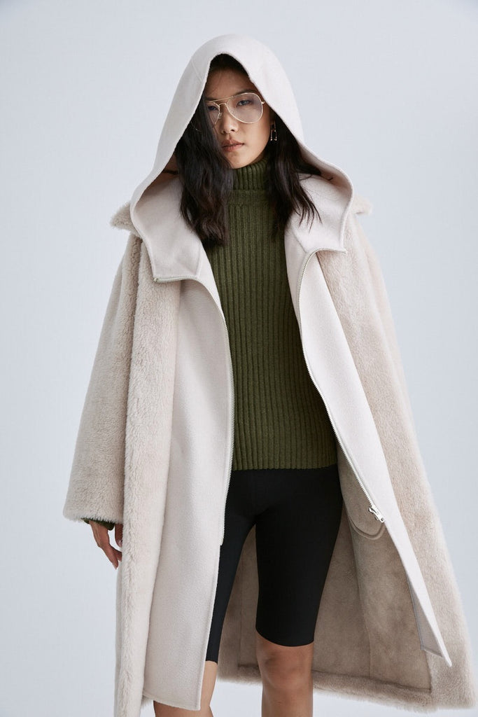 The generous huge boxer hood of the Glacier Faux Shearling coat by Mute by JL will have you reaching for it whenever the temperature plummets. 