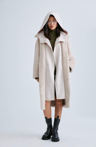 Wrap yourself in this luxurious faux shearling coat in blush by Mute by JL