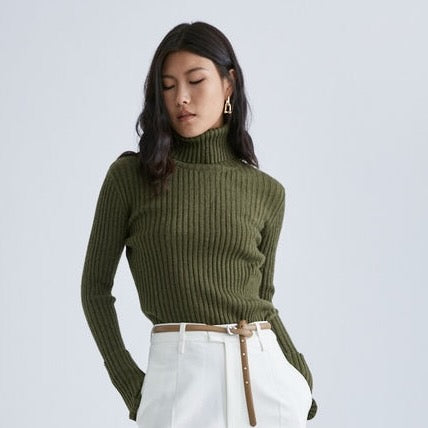 This one size turtleneck is a slim fit layering piece you'll love to live in! Goes-with-everything-olive, and with thumb holes for some extra cozy for your hands. Ribbed and slightly stretchy fabric. Ready for fall and winter!
