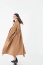 Wrap yourself in this luxurious Lydia cashmere coat by Mute by JL. A stylish antidote to wintry days! Camel color, lapel collar, dropped shoulders and attached matching belt with ruching at the back that accentuates the silhouette.