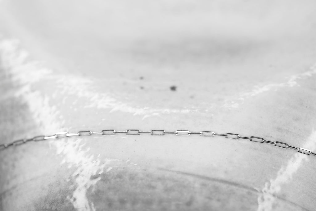 Permanent Jewelry Tiny Paperclip Chain Link Bracelet in white gold. Get Linked at Poet and/the Bench in Mill Valley.