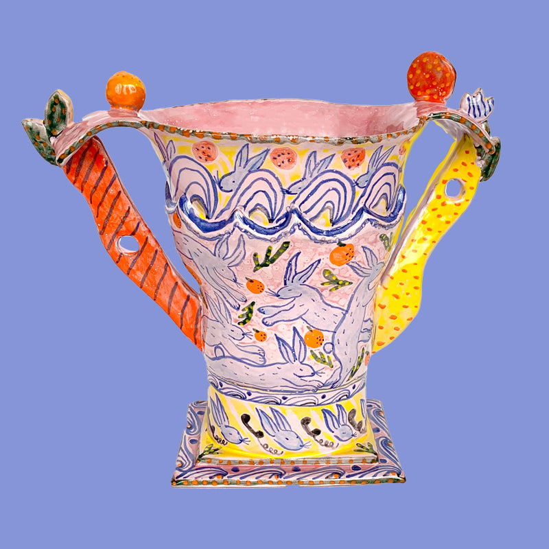 Rabbits talking on the phone and playing in the fields and ocean; and carrot handles make this trophy vessel especially whimsical.