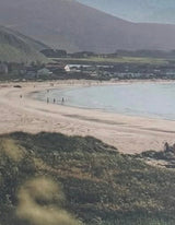 Collage landscape with mountains, ocean, and a cut paper sun in the sky.