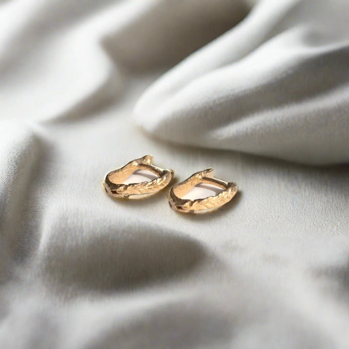 14K gold huggies that click into place; no backs needed. Crooked Fern Leaf Textured Design.