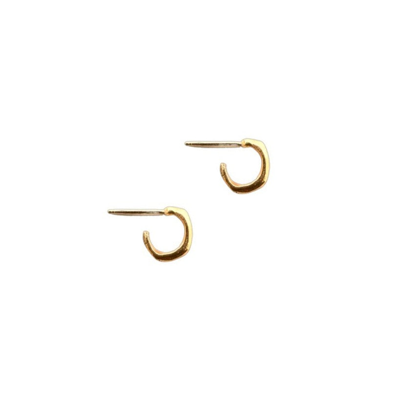 Mini hoops in 14k gold are hand carved and cast to hug the ear lobe. 