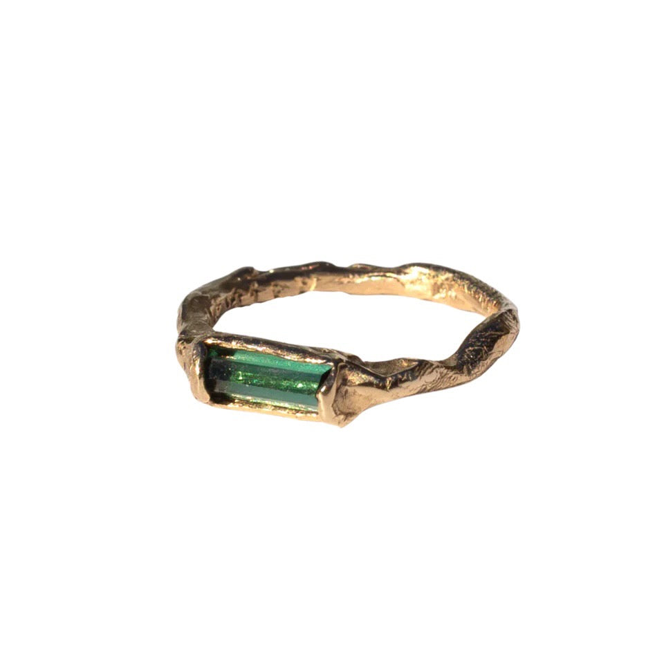 Rich green tourmaline stacking ring has an organic shaped band. Side view.