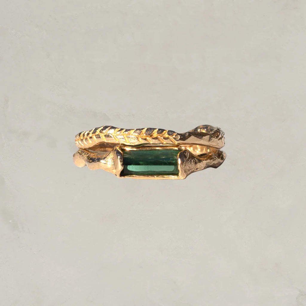 Rich green tourmaline stacking ring has an organic shaped band. Made for stacking or worn individually–designed to be part of a collection of layering rings by spreading them across fingers on both hands. Shown with crooked fern stacking ring.