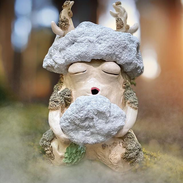 Ceramic monster collects morning fog in the forests of Marin by Spacecat Ceramics. Nimbus wakes up at dawn to collect the morning fog rolling through the trees. He loves how chilly the marine layer feels on his feet and once he's gathered enough, he blows it onto his plant friends to water them before the sun comes up.