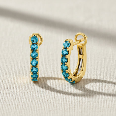 London Blue gemstones in yellow gold hinged huggie hoop earrings
