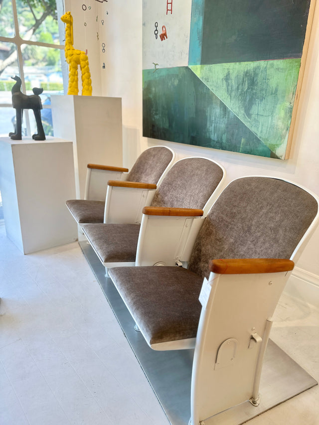 vintage 3-seater stadium chair from burnt orange and scratchy seating to pearlescent white powder coated with grey velvet upholstery over new cushions and with a custom-made base