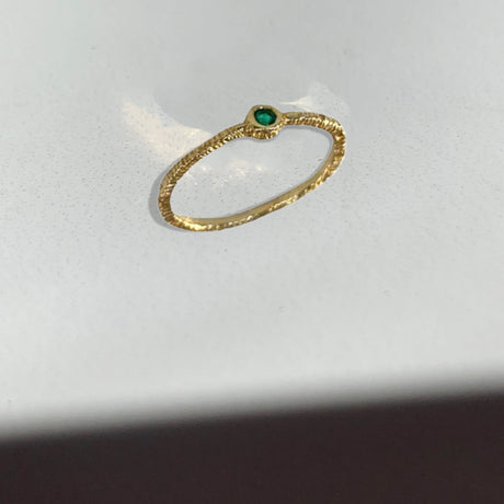 Add an intense green pop and with texture to your every day. Wear this single stone emerald ring by Danielle Welmond alone or make it a stack.