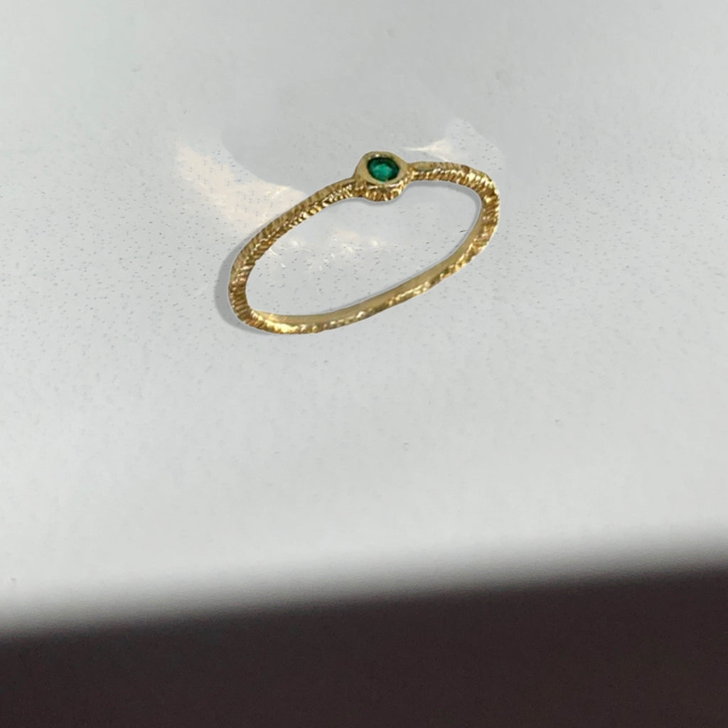 Add an intense green pop and with texture to your every day. Wear this single stone emerald ring by Danielle Welmond alone or make it a stack.