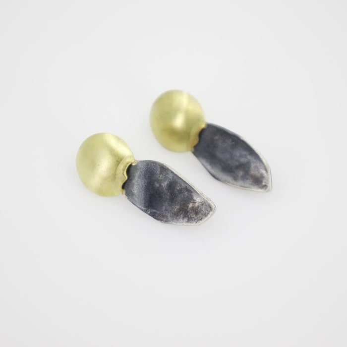 Hand fabricated stud earrings with gold disc "suns" in 14k yellow gold and with torch textured sterling silver, oxidized for dark contrast. These are unique earrings for any event, and comfy enough for everyday wear.