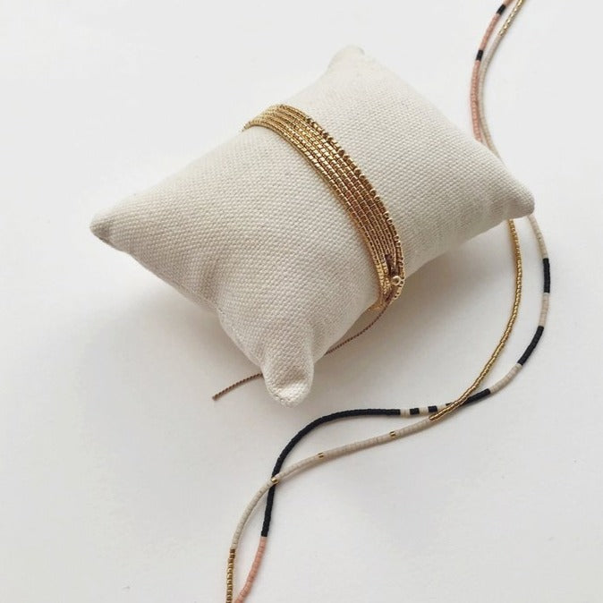 The Gobi is a convertible necklace to wrap bracelet made with 24k gold-plated Japanese glass beads and subtly accented with 14k gold-filled rounds.