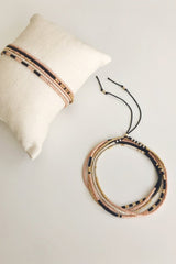 The Sonoran is a convertible necklace to wrap bracelet featuring playful patterns and designs made with Japanese glass beads. Sienna