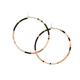 With Abacus Row's Tanami Hoops, designer Christina Trac plays with fixed and open pattern designs. Each earring hoop is hand hammered from 14k gold-filled wire and beaded by hand. These large hoops are whisper light for everyday adornment. Sienna