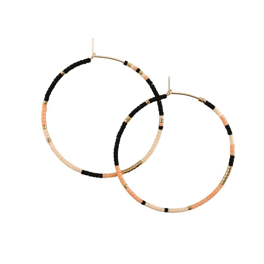 With Abacus Row's Tanami Hoops, designer Christina Trac plays with fixed and open pattern designs. Each earring hoop is hand hammered from 14k gold-filled wire and beaded by hand. These large hoops are whisper light for everyday adornment. Sienna