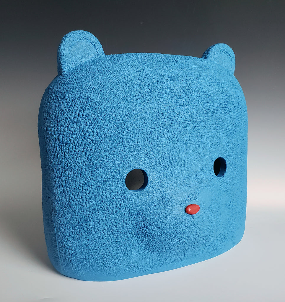 A textured blue bear head by Austyn Taylor that speaks to reality, symbols, and society–and our understanding of shared existence. 