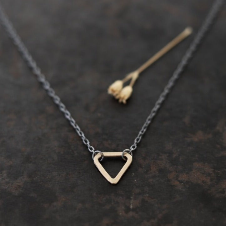 With three sides, and the number three thought to be a magical number, Esther Metals designed this everyday triangle necklace to be your lucky charm. 