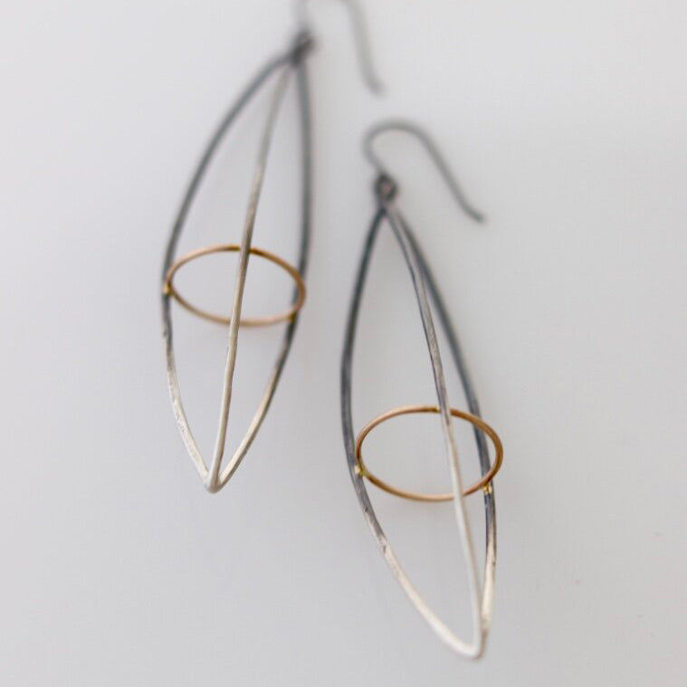 These dramatic earrings hold the Earth within the atmosphere or your inner thoughts among the cosmos. We love how the gold details pop in contrast to the oxidized silver. This version is extra long. 