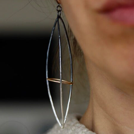 These dramatic earrings hold the Earth within the atmosphere or your inner thoughts among the cosmos. We love how the gold details pop in contrast to the oxidized silver. This version is extra long. 