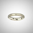 Jeffrey's hand carved style makes this perfectly imperfect unisex round ring a stunning stacker with scattered black diamonds. 
