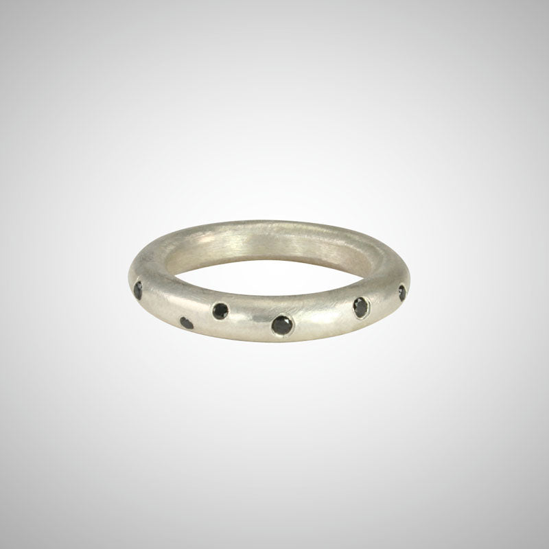 Jeffrey's hand carved style makes this perfectly imperfect unisex round ring a stunning stacker with scattered black diamonds. 