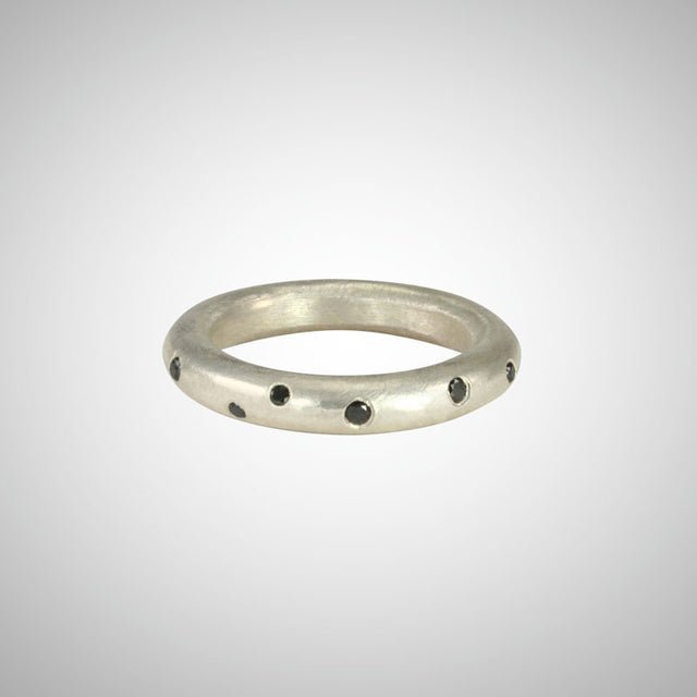 Jeffrey's hand carved style makes this perfectly imperfect unisex round ring a stunning stacker with scattered black diamonds. 