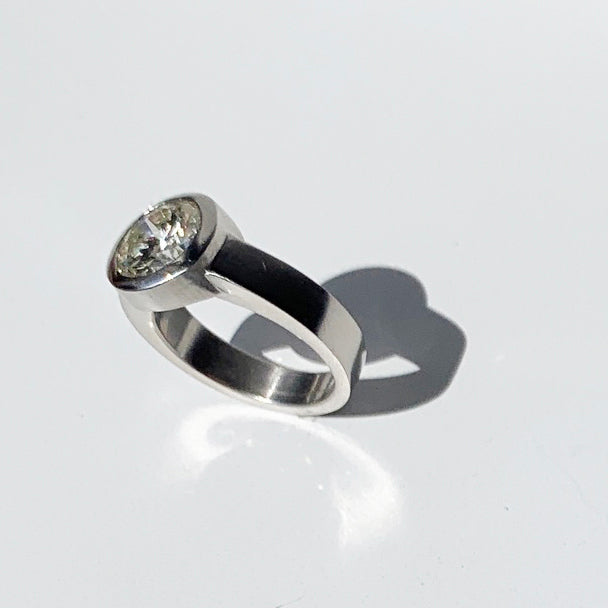 This platinum modern solitaire design originated as a bespoke engagement ring by Poet and/the Bench co-founder and goldsmith Jeffrey Levin. 