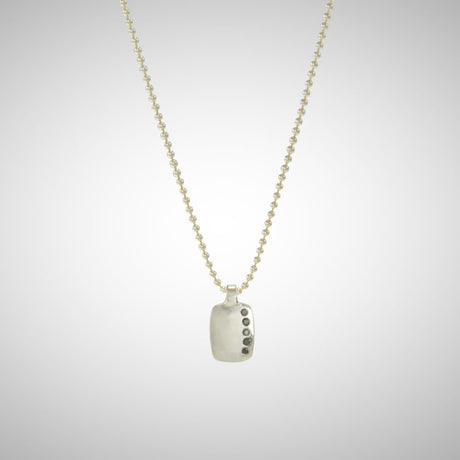 Jeffrey reimagined the classic dog tag into a modern canvas, both refined and a bit edgy. A river of black diamonds give this wabi sabi version beauty in the imperfections and elegance in simplicity. 