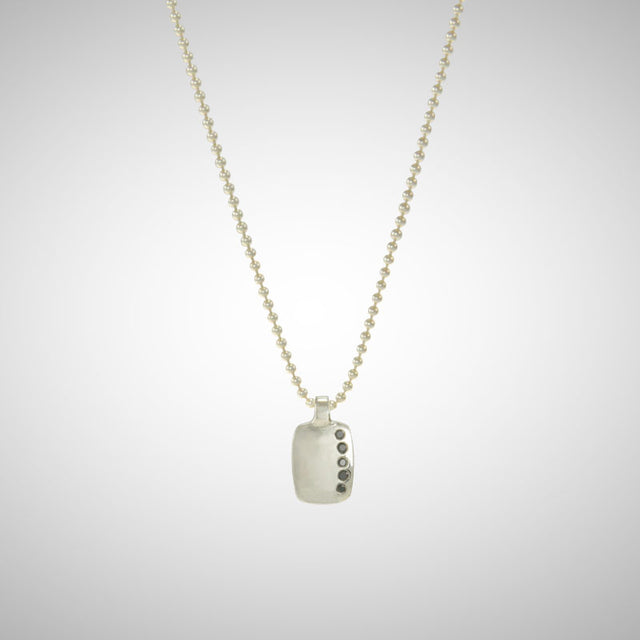 Jeffrey reimagined the classic dog tag into a modern canvas, both refined and a bit edgy. A river of black diamonds give this wabi sabi version beauty in the imperfections and elegance in simplicity. 