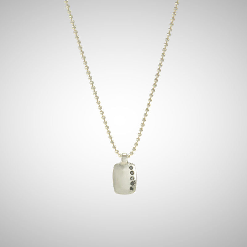 Jeffrey reimagined the classic dog tag into a modern canvas, both refined and a bit edgy. A river of black diamonds give this wabi sabi version beauty in the imperfections and elegance in simplicity. 