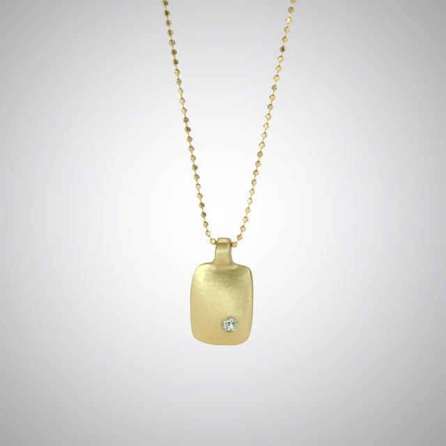 Jeffrey reimagined the classic dog tag into a modern canvas, both refined and a bit edgy. This is a classic version in 14 gold with a single diamond.