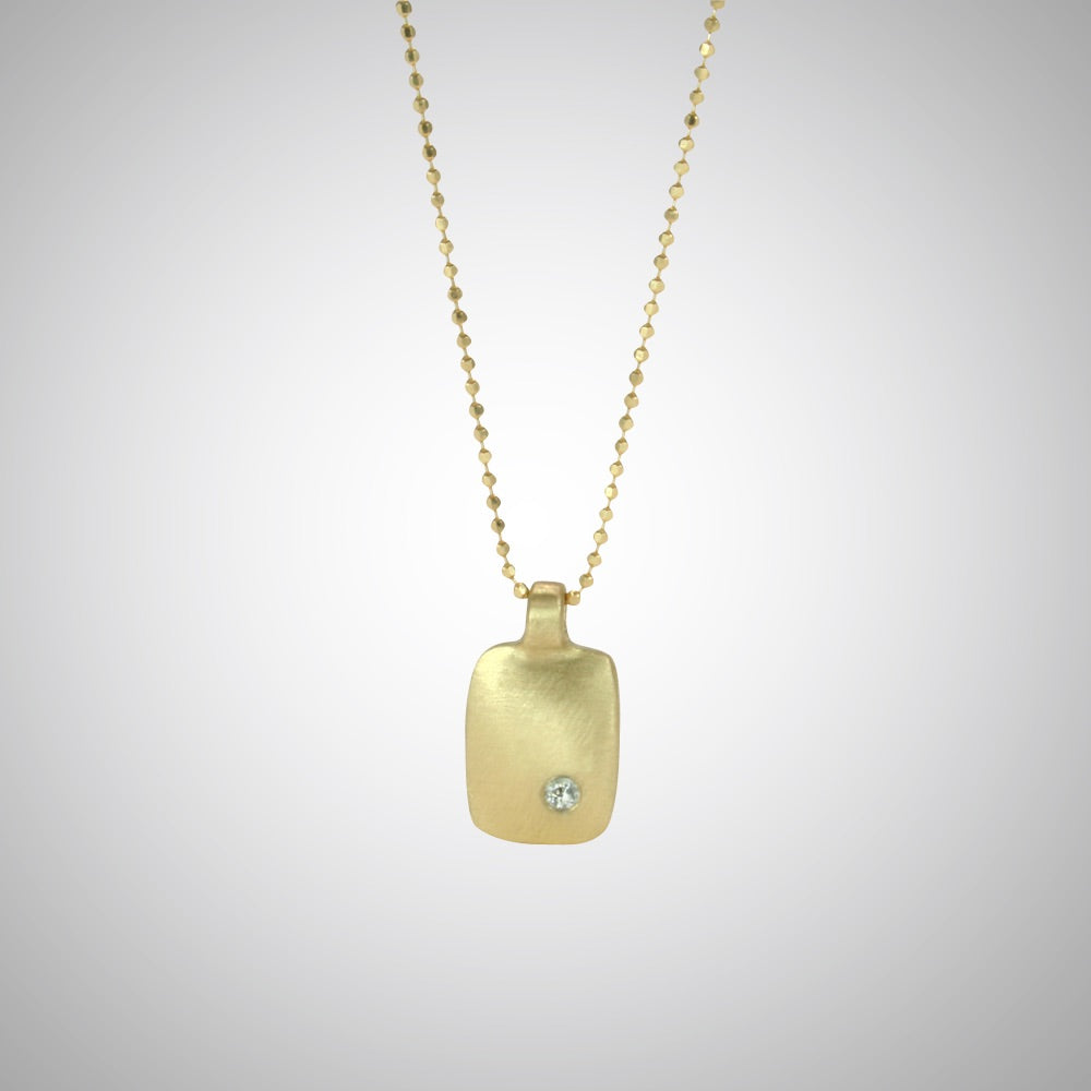 Jeffrey reimagined the classic dog tag into a modern canvas, both refined and a bit edgy. This is a classic version in 14 gold with a single diamond.
